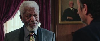 Movie still from “Now You See Me 2” (2016), directed by Jon M. Chu – An older man wearing a suit and a tie; Close Up shot, Low angle