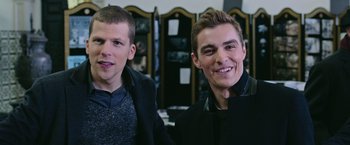 Movie still from “Now You See Me 2” (2016), directed by Jon M. Chu – Two young men sitting next to each other in a room; Medium shot, High angle