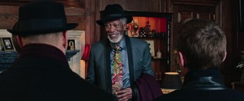 Movie still from “Now You See Me 2” (2016), directed by Jon M. Chu – An older man wearing a suit and a hat; Medium shot, Over the shoulder angle