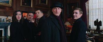 Movie still from “Now You See Me 2” (2016), directed by Jon M. Chu – A man wearing a hat and a black coat standing next to another man in a black hat; Medium shot, Over the shoulder angle