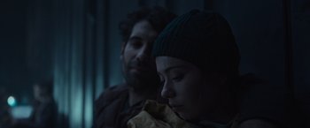 Movie still from “Nowhere” (2023), directed by Albert Pintó – A man and a woman sitting next to each other in the dark; Close Up shot, Low angle