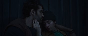 Movie still from “Nowhere” (2023), directed by Albert Pintó – A man and a woman sitting next to each other; Close Up shot, Overhead angle