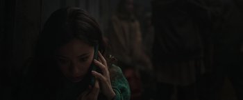 Movie still from “Nowhere” (2023), directed by Albert Pintó – A woman holding a cell phone up to her ear; Close Up shot, High angle
