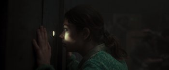 Movie still from “Nowhere” (2023), directed by Albert Pintó – A girl is looking at her phone in the dark; Close Up shot, Over the shoulder angle
