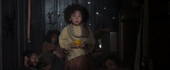 Movie still from “Nowhere” (2023), directed by Albert Pintó – A young girl holding a yellow object in her hands; Medium shot, High angle