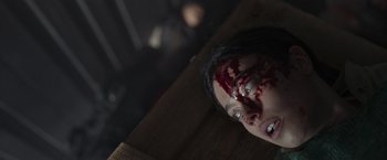 Movie still from “Nowhere” (2023), directed by Albert Pintó – A woman with blood all over her face; Close Up shot, Overhead angle