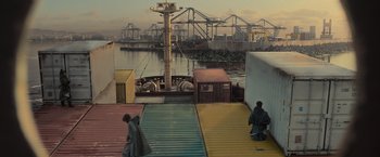 Movie still from “Nowhere” (2023), directed by Albert Pintó – Two men are sitting on a dock looking at a boat; Extreme Wide shot, High angle