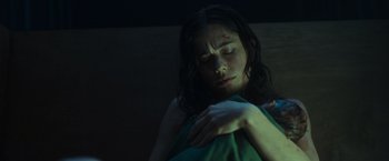 Movie still from “Nowhere” (2023), directed by Albert Pintó – A woman is laying in a bed with her eyes closed; Close Up shot, Low angle