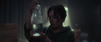 Movie still from “Nowhere” (2023), directed by Albert Pintó – A woman holding a bottle of pills in her hand; Close Up shot, High angle