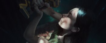 Movie still from “Nowhere” (2023), directed by Albert Pintó – A woman drinking a beer in a dark room; Close Up shot, Overhead angle