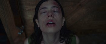 Movie still from “Nowhere” (2023), directed by Albert Pintó – A woman with bruises on her face and neck; Close Up shot, Overhead angle