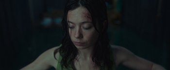 Movie still from “Nowhere” (2023), directed by Albert Pintó – A young woman with bruises on her face; Close Up shot, High angle