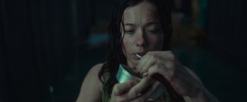 Movie still from “Nowhere” (2023), directed by Albert Pintó – A woman is holding a can of soda in her hands; Close Up shot, High angle