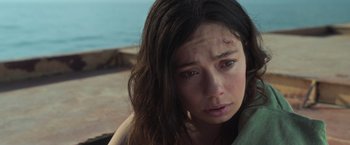 Movie still from “Nowhere” (2023), directed by Albert Pintó – A woman with a scar on her face looking at the camera; Close Up shot, Over the shoulder angle