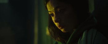 Movie still from “Nowhere” (2023), directed by Albert Pintó – A young woman is looking at the camera; Close Up shot, Low angle