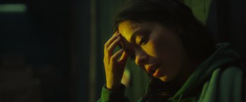 Movie still from “Nowhere” (2023), directed by Albert Pintó – A woman is holding her hand up to her head; Close Up shot, Low angle