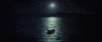 Movie still from “Nowhere” (2023), directed by Albert Pintó – A boat in the middle of the ocean under a full moon at night; Extreme Wide shot, Low angle