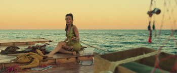 Movie still from “Nowhere” (2023), directed by Albert Pintó – A woman sitting on the bow of a small boat; Wide shot, High angle