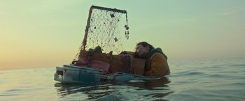 Movie still from “Nowhere” (2023), directed by Albert Pintó – A person in a boat in a body of water; Extreme Wide shot, Low angle