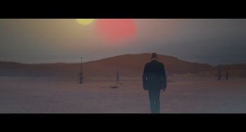 Movie still from “Obi-Wan Kenobi: A Jedi's Return” (2022), directed by David Gelb – A man in a suit walking in the desert; Wide shot, Low angle