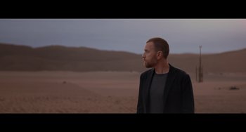 Movie still from “Obi-Wan Kenobi: A Jedi's Return” (2022), directed by David Gelb – A man standing in the middle of the desert; Medium shot, Over the shoulder angle