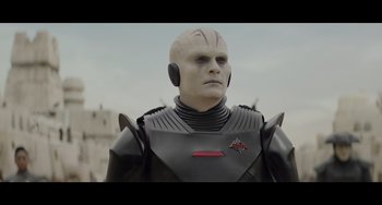 Movie still from “Obi-Wan Kenobi: A Jedi's Return” (2022), directed by David Gelb – An image of a man in a suit and helmet; Close Up shot, Over the shoulder angle