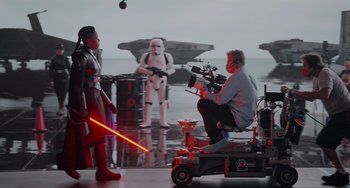 Movie still from “Obi-Wan Kenobi: A Jedi's Return” (2022), directed by David Gelb – A man is filming a scene for a star wars movie; Wide shot, Over the shoulder angle