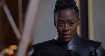 Movie still from “Obi-Wan Kenobi: A Jedi's Return” (2022), directed by David Gelb – A woman in a black leather jacket looking to her left; Close Up shot, Over the shoulder angle