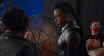 Movie still from “Obi-Wan Kenobi: A Jedi's Return” (2022), directed by David Gelb – A woman standing next to another woman in a room; Medium shot, Over the shoulder angle