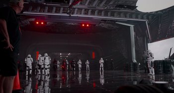 Movie still from “Obi-Wan Kenobi: A Jedi's Return” (2022), directed by David Gelb – A number of people in costumes in a dark room; Extreme Wide shot, High angle