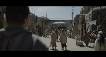 Movie still from “Obi-Wan Kenobi: A Jedi's Return” (2022), directed by David Gelb – A group of people standing in front of a building; Wide shot, Over the shoulder angle