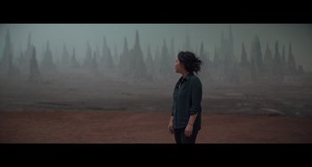 Movie still from “Obi-Wan Kenobi: A Jedi's Return” (2022), directed by David Gelb – A woman standing in front of a field with trees in the background; Extreme Wide shot, High angle