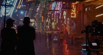 Movie still from “Obi-Wan Kenobi: A Jedi's Return” (2022), directed by David Gelb – A man standing in the middle of a city at night; Wide shot, Over the shoulder angle