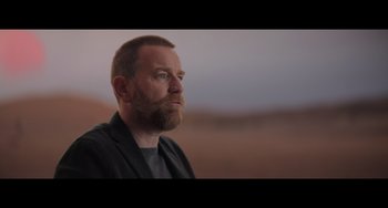 Movie still from “Obi-Wan Kenobi: A Jedi's Return” (2022), directed by David Gelb – A man with a goatee is looking off into the distance; Close Up shot, Low angle