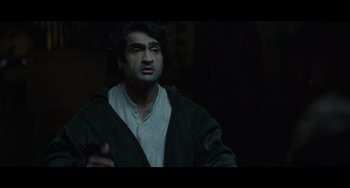 Movie still from “Obi-Wan Kenobi: A Jedi's Return” (2022), directed by David Gelb – A man in a black jacket is standing in the dark; Close Up shot, Over the shoulder angle