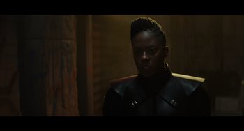 Movie still from “Obi-Wan Kenobi: A Jedi's Return” (2022), directed by David Gelb – A man in a black jacket standing in a dark room; Close Up shot, Over the shoulder angle