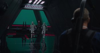 Movie still from “Obi-Wan Kenobi: A Jedi's Return” (2022), directed by David Gelb – A group of people in a room with a green screen in the background; Wide shot, Over the shoulder angle
