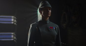 Movie still from “Obi-Wan Kenobi: A Jedi's Return” (2022), directed by David Gelb – A woman dressed in a green uniform and a hat; Close Up shot, Low angle