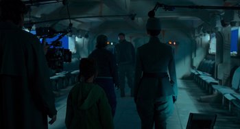 Movie still from “Obi-Wan Kenobi: A Jedi's Return” (2022), directed by David Gelb – A group of people walking down a hallway in a building; Wide shot, Over the shoulder angle