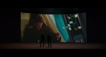 Movie still from “Obi-Wan Kenobi: A Jedi's Return” (2022), directed by David Gelb – Two men standing in front of a large screen; Wide shot, Over the shoulder angle