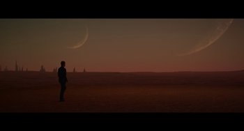 Movie still from “Obi-Wan Kenobi: A Jedi's Return” (2022), directed by David Gelb – A man standing in the middle of an empty field; Extreme Wide shot, Over the shoulder angle