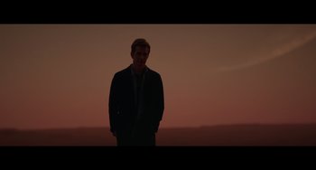 Movie still from “Obi-Wan Kenobi: A Jedi's Return” (2022), directed by David Gelb – A man standing in the middle of a field at night; Medium shot, Low angle