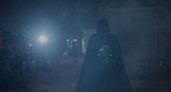 Movie still from “Obi-Wan Kenobi: A Jedi's Return” (2022), directed by David Gelb – A darth vader in a dark city at night; Wide shot, Over the shoulder angle