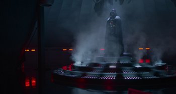 Movie still from “Obi-Wan Kenobi: A Jedi's Return” (2022), directed by David Gelb – A darth vader statue in the middle of a building; Wide shot, Low angle