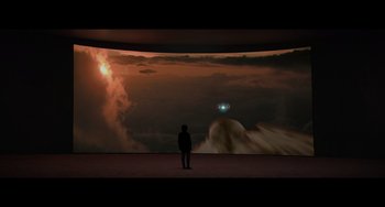 Movie still from “Obi-Wan Kenobi: A Jedi's Return” (2022), directed by David Gelb – A person standing in front of a large screen; Extreme Wide shot, Low angle