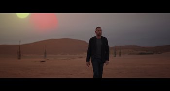 Movie still from “Obi-Wan Kenobi: A Jedi's Return” (2022), directed by David Gelb – A man walking in the middle of the desert; Wide shot, Over the shoulder angle