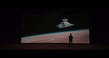 Movie still from “Obi-Wan Kenobi: A Jedi's Return” (2022), directed by David Gelb – A man standing in front of a star destroyer in space; Extreme Wide shot, Low angle