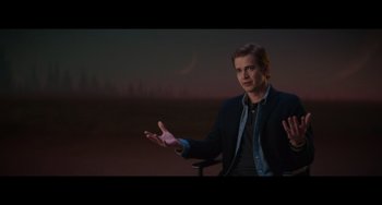 Movie still from “Obi-Wan Kenobi: A Jedi's Return” (2022), directed by David Gelb – A man in a black jacket is talking to someone; Medium shot, Over the shoulder angle