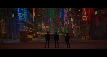 Movie still from “Obi-Wan Kenobi: A Jedi's Return” (2022), directed by David Gelb – Three people standing in front of a neon lit city; Extreme Wide shot, High angle