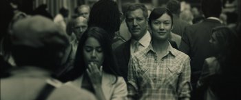 Movie still from “Oblivion” (2013), directed by Joseph Kosinski – A black and white photo of a group of people; Close Up shot, Over the shoulder angle